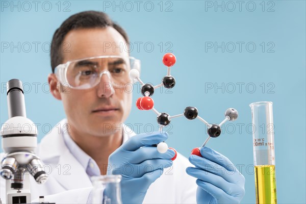 Scientist holding molecule model