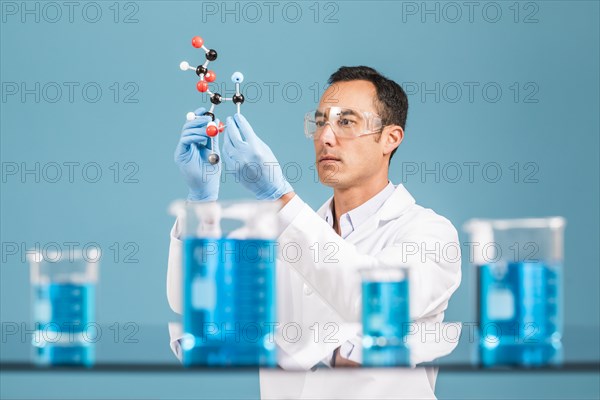 Scientist holding molecule model