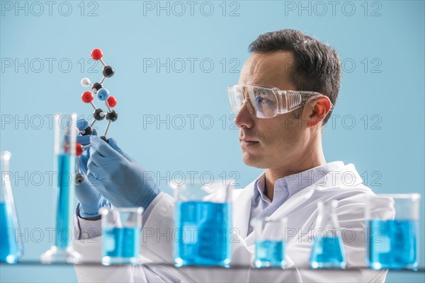 Scientist holding molecule model