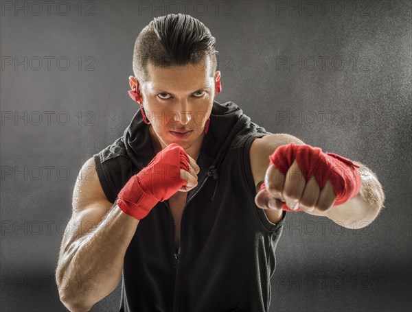 Portrait of muscular man in boxing stance