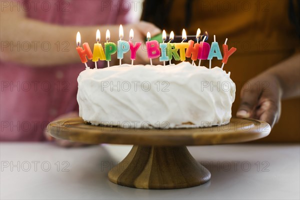 Birthday cake with candles on cakestand