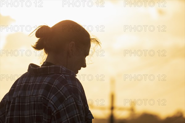 Silhouette of woman against sunset sky