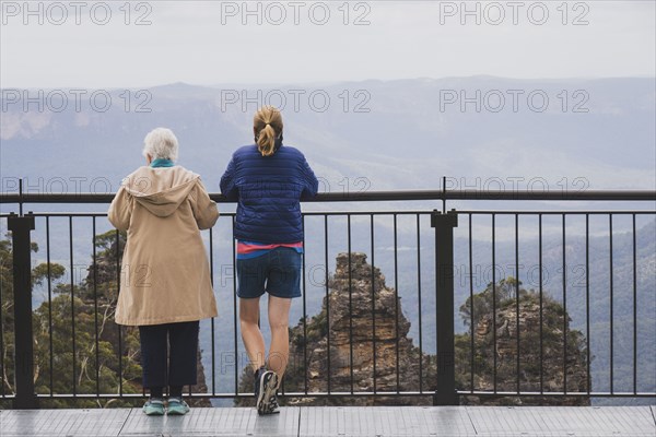 Rear view of two women standing together