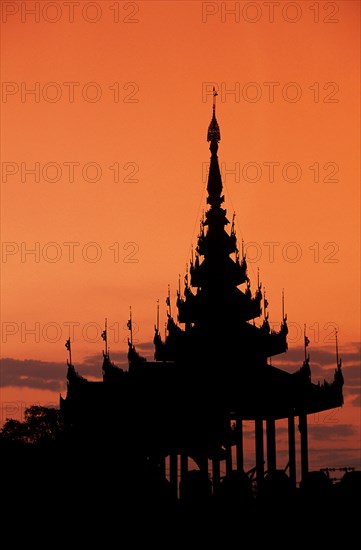 Silhouette of Buddhist temple at sunset