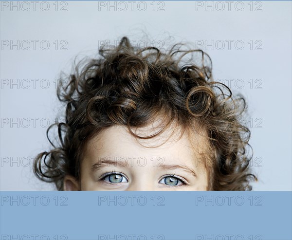 Portrait of little girl behind desk