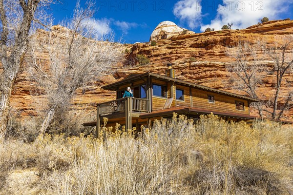 Woman on deck of home in canyon in Grand Staircase-Escalante National Monument