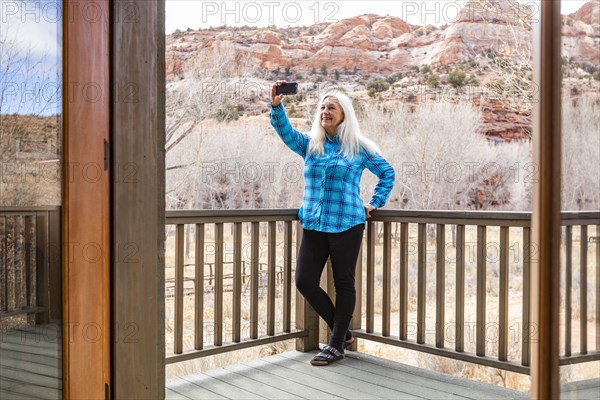 Woman on deck of home in canyon in Grand Staircase-Escalante National Monument