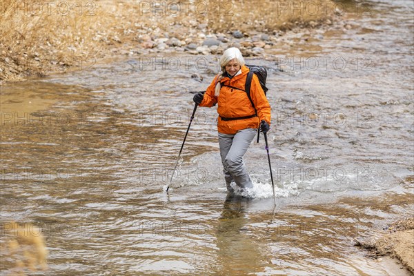 Woman wading across Escalante River in Grand Staircase-Escalante National Monument