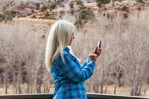 Woman using smart phone in Grand Staircase-Escalante National Monument
