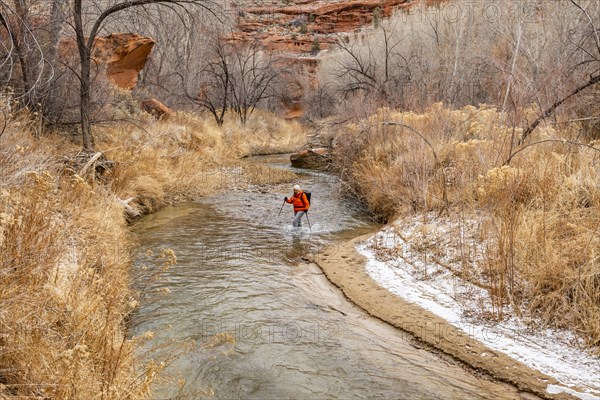 Woman wading across Escalante River in Grand Staircase-Escalante National Monument