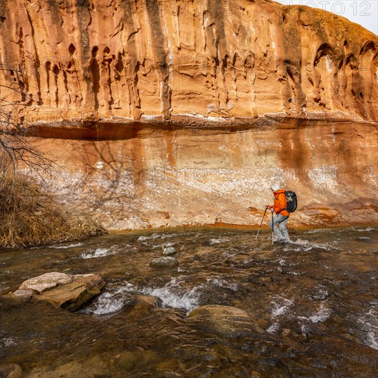 Woman wading across Escalante River in Grand Staircase-Escalante National Monument