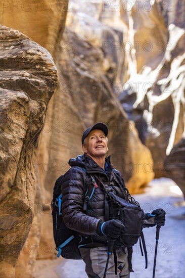 Man hiking in slot canyon in Grand Staircase-Escalante National Monument