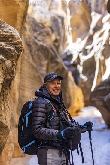 Man hiking in slot canyon in Grand Staircase-Escalante National Monument