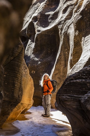 Woman hiking in slot canyon in Grand Staircase-Escalante National Monument