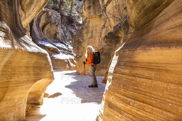 Woman hiking in slot canyon in Grand Staircase-Escalante National Monument