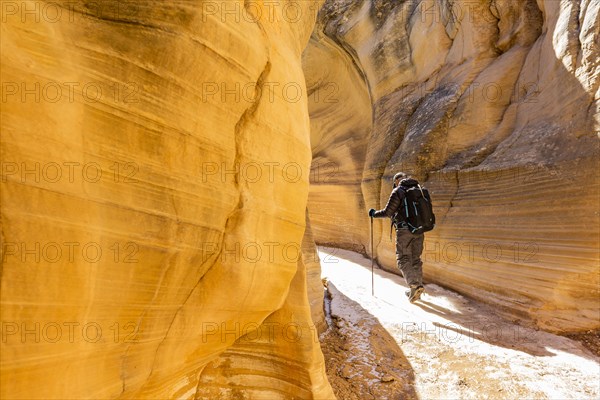 Man hiking in slot canyon in Grand Staircase-Escalante National Monument