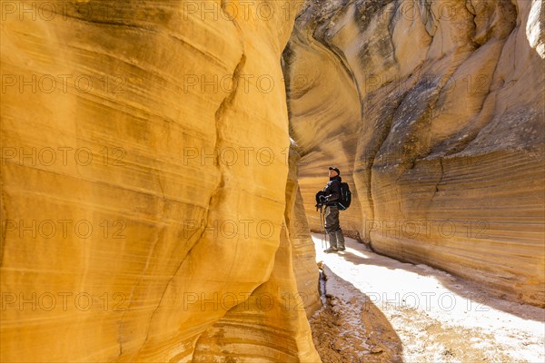 Man hiking in slot canyon in Grand Staircase-Escalante National Monument