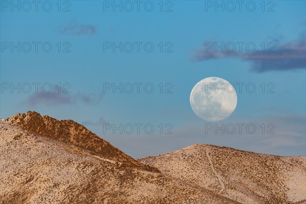 Full moon over foothills