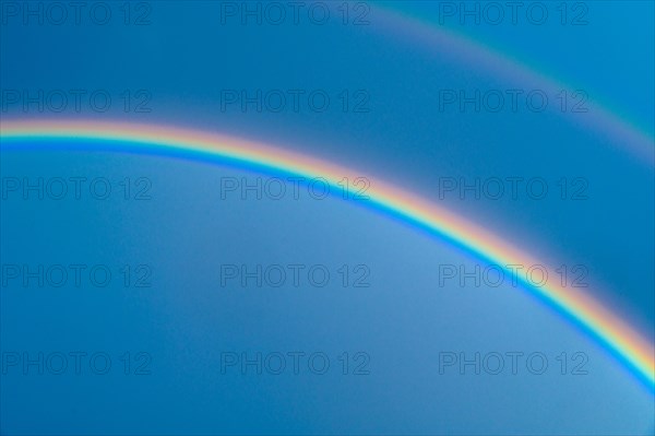 Double rainbow on blue sky