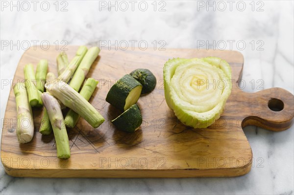 Vegetable scraps ready for compost on wooden cutting board