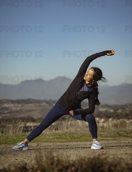 Woman stretching in landscape