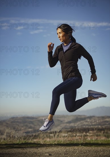 Woman jumping in landscape