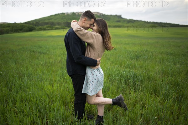 Young couple embracing in wheat field