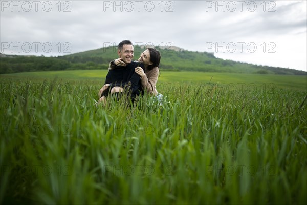 Young couple embracing in wheat field