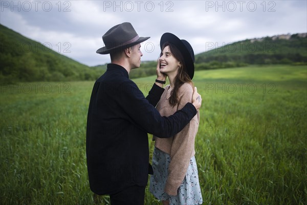 Smiling young couple in wheat field