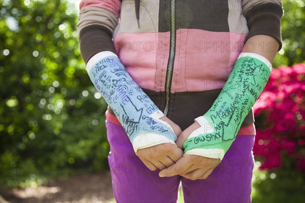 Girl (12-13) with two arm casts