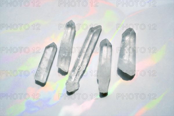 Transparent quartz crystals with rainbow light background