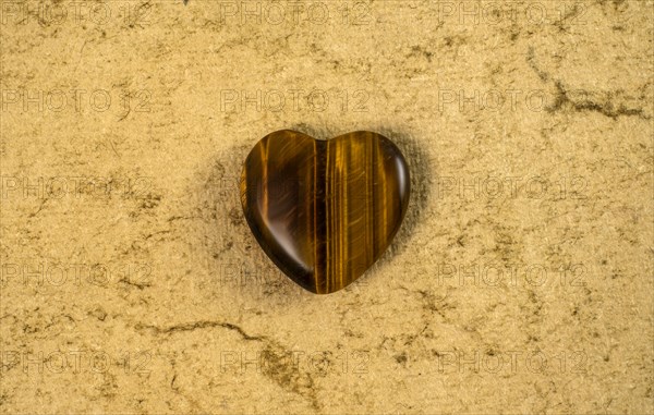 Wooden heart on beige background