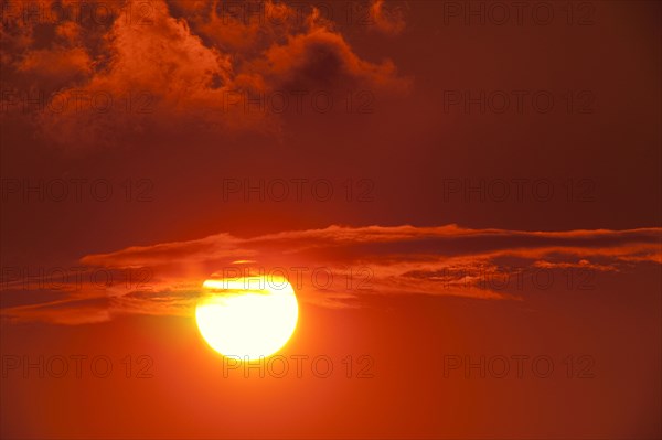 Setting sun among clouds