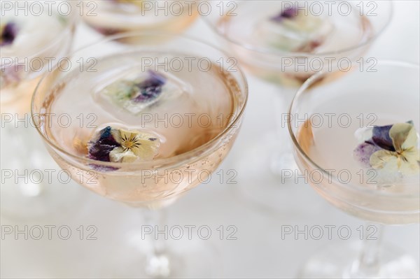Sparkling rose wine with edible flower garnish