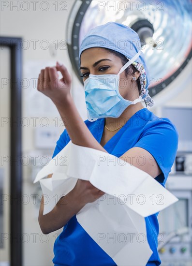 Female doctor preparing for surgery in operating theater