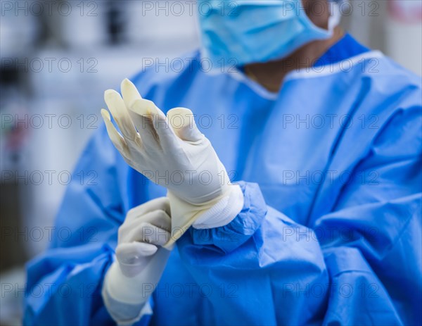 Female doctor preparing for surgery in operating theater