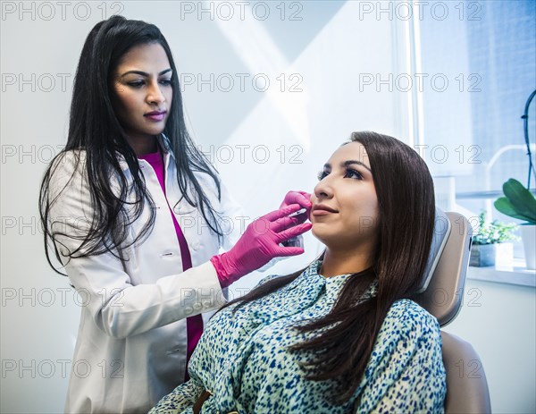 Doctor checking results of plastic surgery