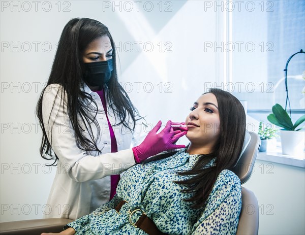 Patient receiving injection on her face