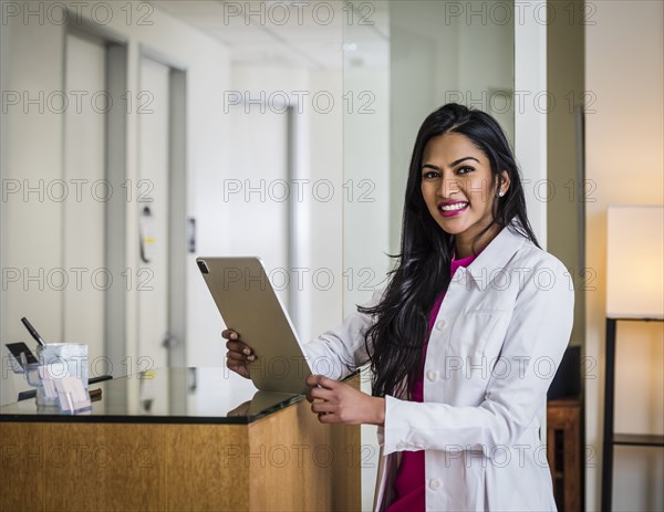 Portrait of female doctor at reception desk