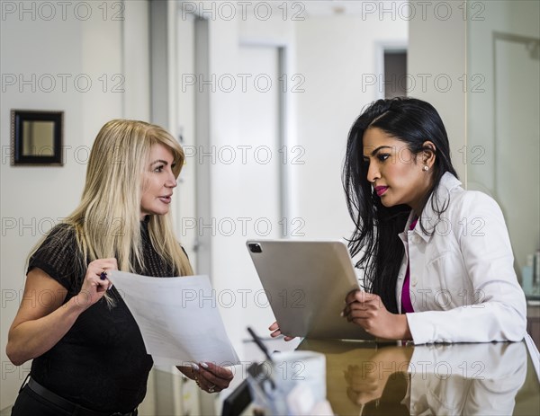 Doctor talking with patient at reception desk
