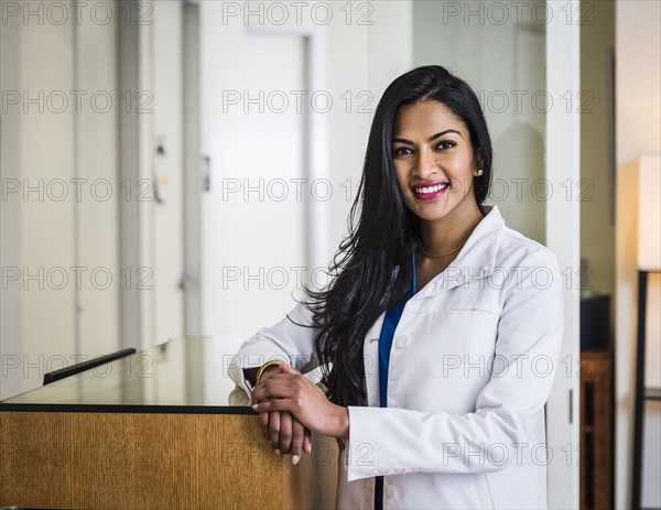 Portrait of female doctor at reception desk