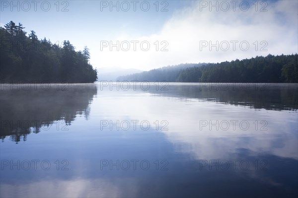 Usa, New York State, Morning fog on Upper Saranac Lake