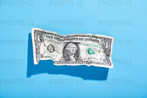 One dollar bill on blue background