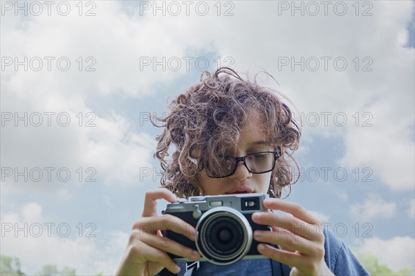 Boy taking picture with camera