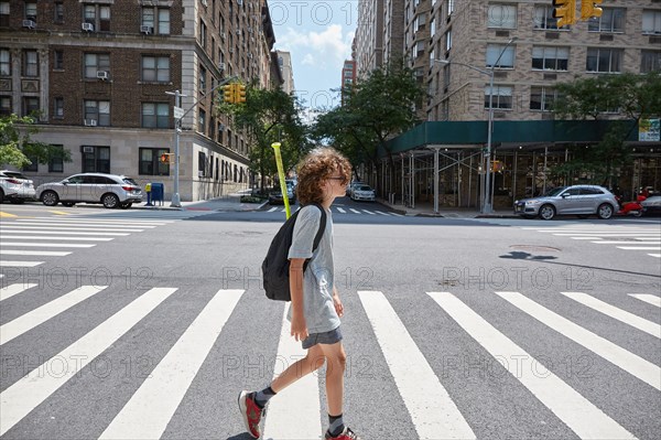 USA, New York, New York City, Boy crossing street