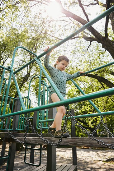 USA, New York, New York City, Girl walking on footbridge on playground