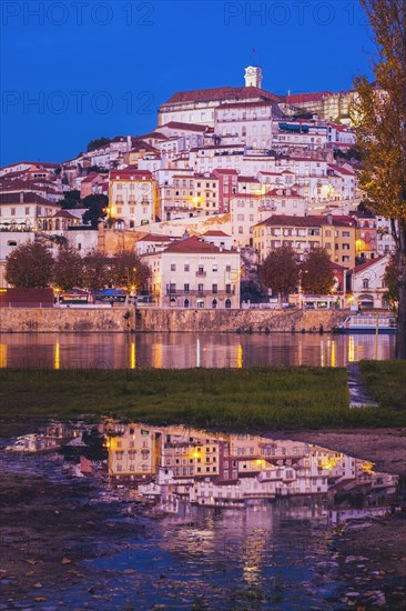 Portugal, Centro Region, Coimbra, Buildings reflecting in water