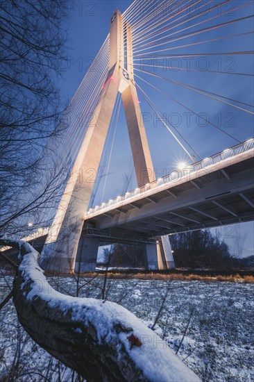 Poland, Subcarpathia, Rzeszow, Suspension bridge at night in winter