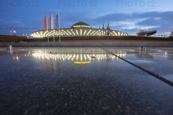 Poland, Holy Cross, Kielce, Bus station reflecting in puddle