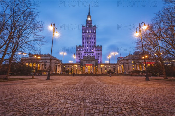 Poland, Masovia, Warsaw, Illuminated high rise building at town square